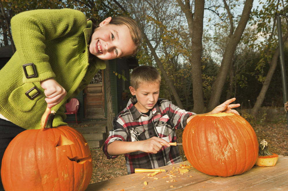 Kids carving pumpkins