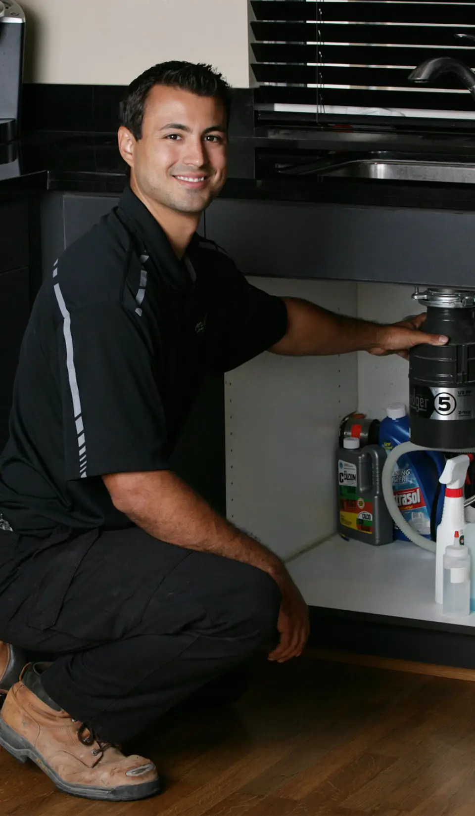 Plumber unclogging a sink