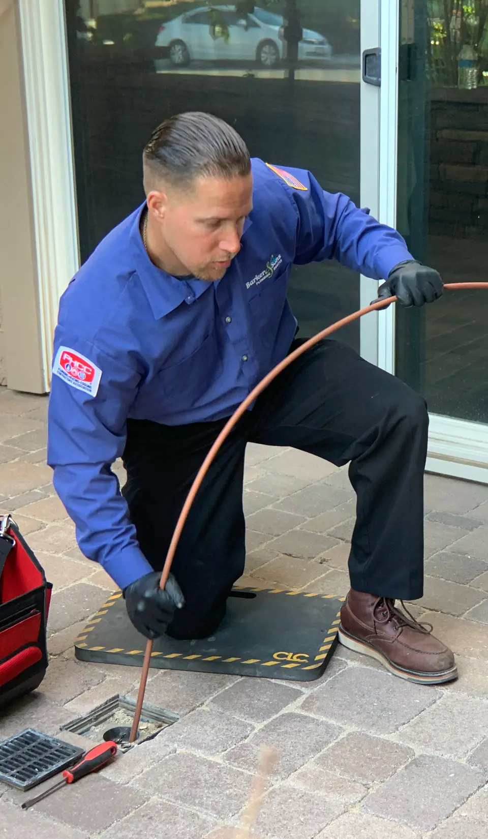 Barker & Sons employee doing emergency plumbing services at an Anaheim home