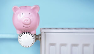 pink piggy bank sitting on dial of heater in blue room