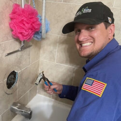 Barker and Sons technician installing bath fixtures in a customers home