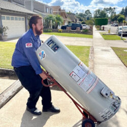Barker and Sons technician installing a water heater in a customers home.