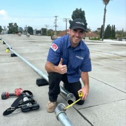 Barker and Sons technician measuring pipes for an installation job