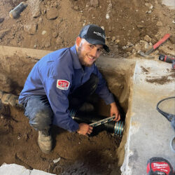 Barker and Sons technician performing drain inspection on a customers home