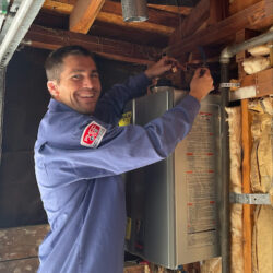 Barker and Sons technician performing drain inspection on a customers home