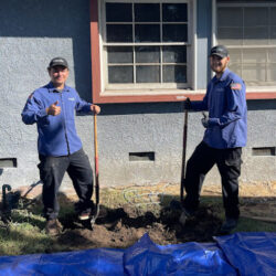 Barker and Sons technicians digging in customers yard to perform drain inspections