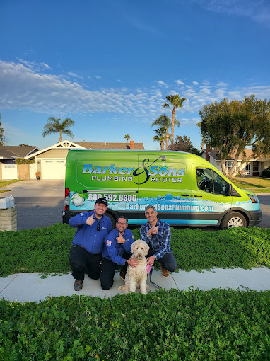 Barker and Sons team posing with a happy client and his dog.