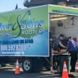 Barker and Sons technicians cleaning and replacing a sewer.