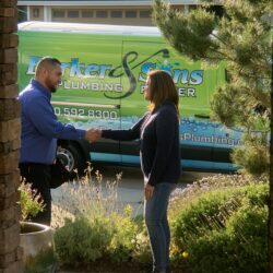Barker and Sons technician shaking hands with a happy customer after a job well done