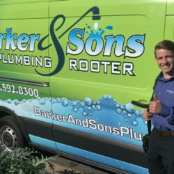 Barker and Sons technician posing in front of one of their service trucks