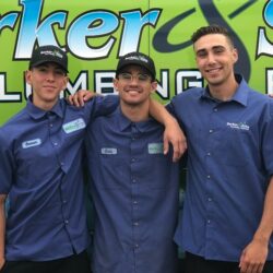 Barker and Sons technicians posing for a team photo in from of one of their service trucks.