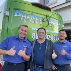 Barker and Sons technician posing with a happy customer after a job well done.